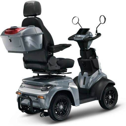 De IVA K1000 scootmobiel is een strakke, zilveren scootmobiel met een comfortabele zwarte zitting, rugleuning en armleuningen. Inclusief opbergvak, stuur met spiegels en vier stevige wielen voor extra stabiliteit.
